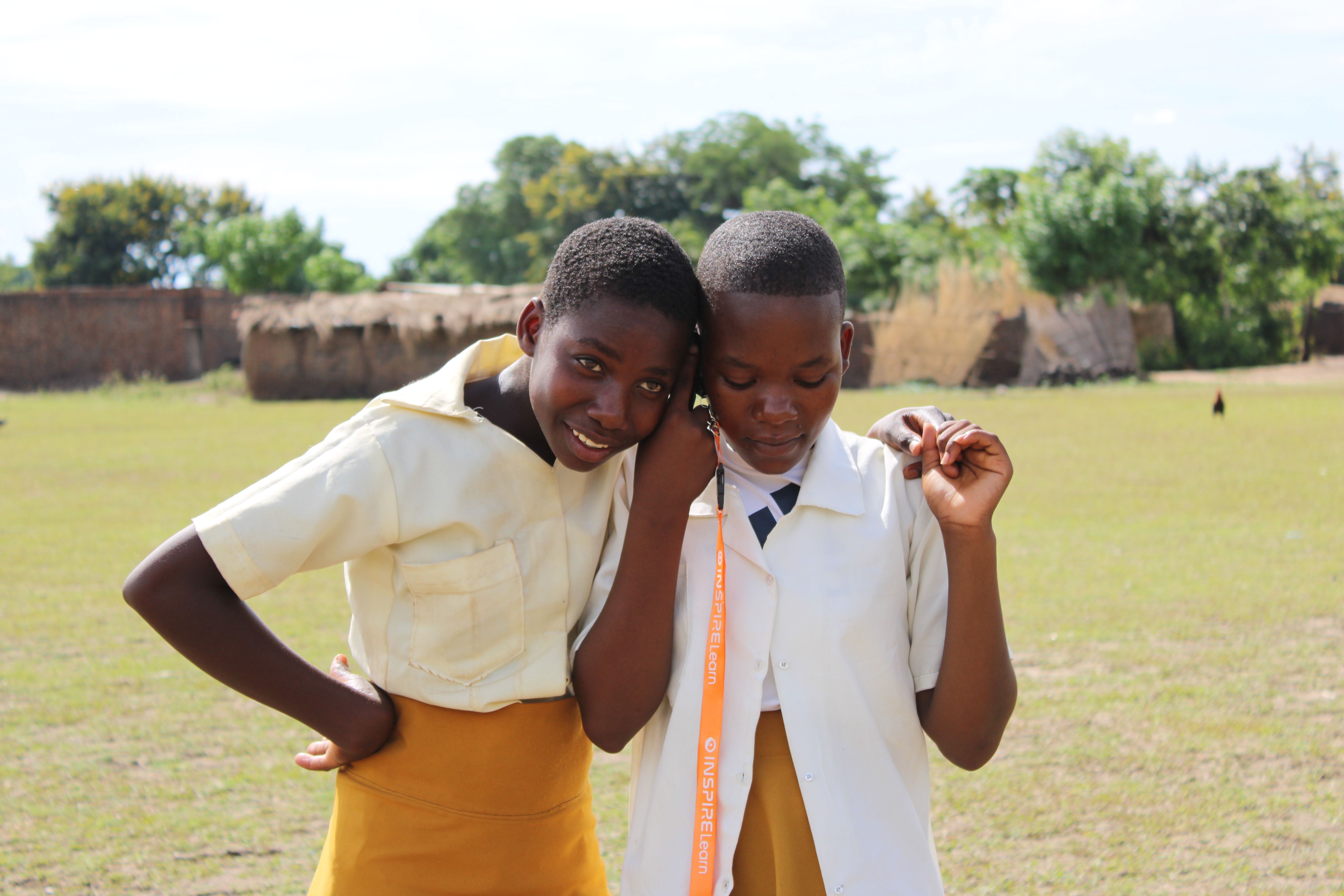 Two students holding a phone while learning